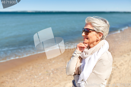 Image of portrait of senior woman in sunglasses on beach