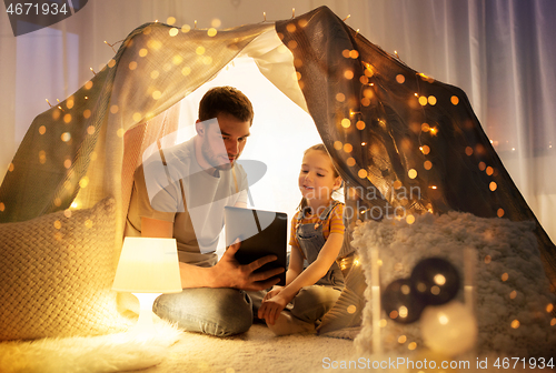 Image of family with tablet pc in kids tent at home