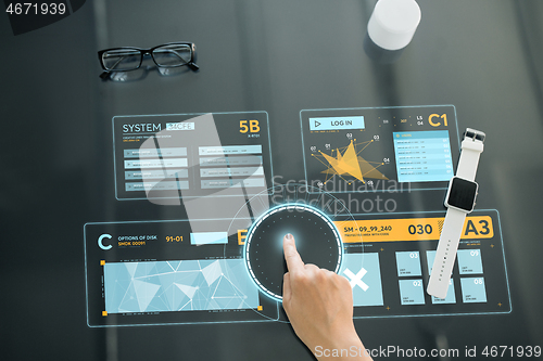 Image of close up of hand using interactive panel with data