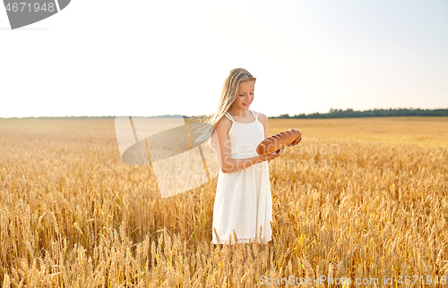 Image of girl with loaf of white bread on cereal field