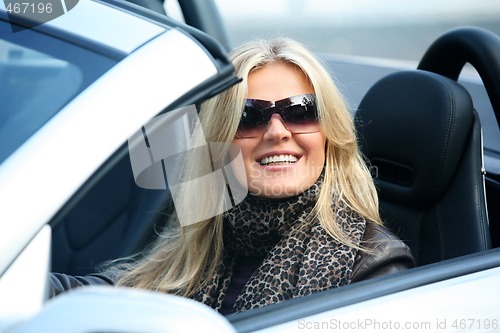 Image of Blond smiling woman in a car