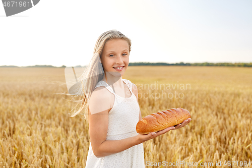 Image of girl with loaf of white bread on cereal field