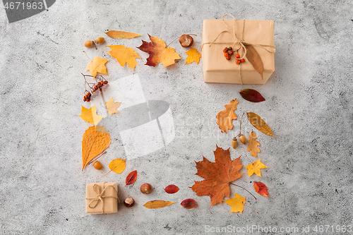 Image of frame of gifts, autumn leaves and rowanberry