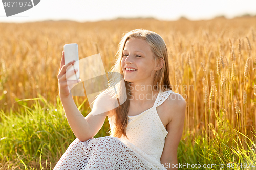 Image of happy young girl taking selfie by smartphone