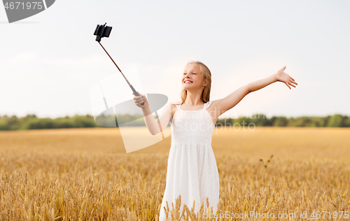 Image of happy young girl taking selfie by smartphone