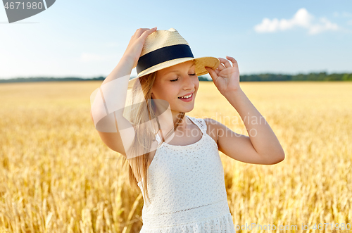 Image of portrait of girl in straw hat on field in summer