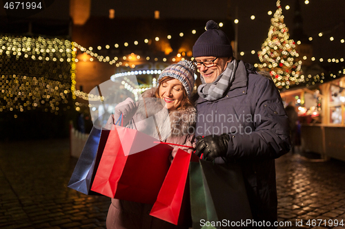 Image of old couple at christmas market with shopping bags