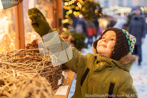 Image of happy little boy at christmas market in winter