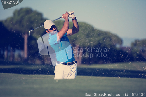 Image of pro golfer hitting a sand bunker shot