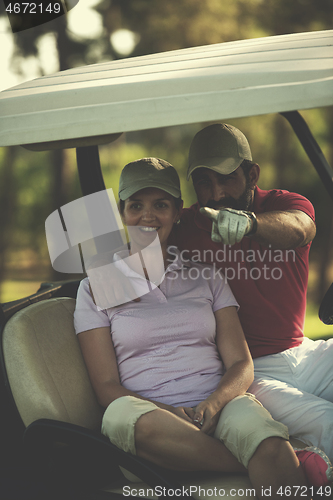 Image of couple in buggy on golf course