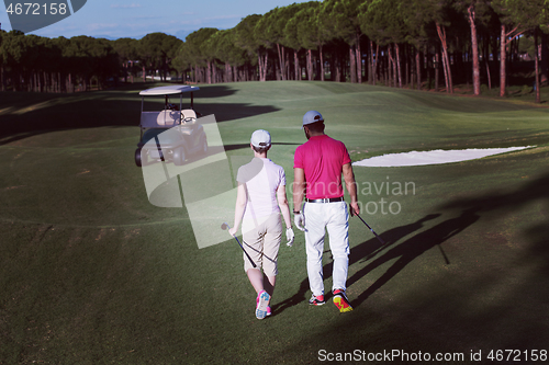 Image of couple walking on golf course