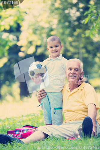 Image of grandfather and child have fun  in park