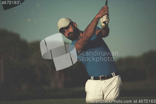 Image of pro golfer hitting a sand bunker shot