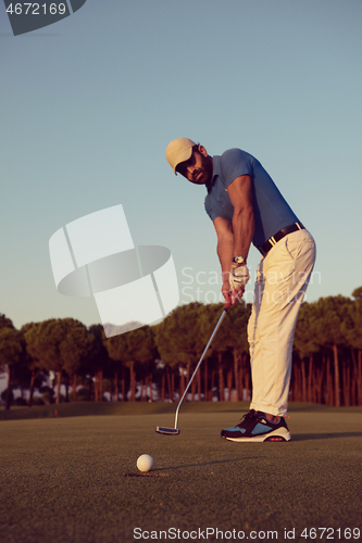 Image of golfer  hitting shot at golf course