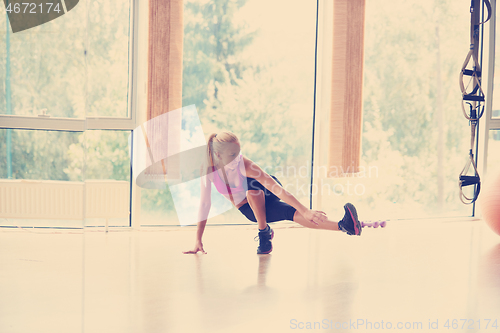 Image of woman stretching and warming up for her training at a gym