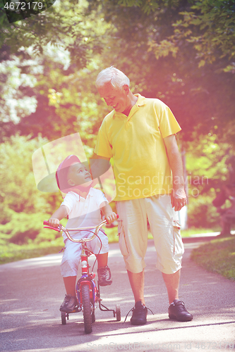 Image of happy grandfather and child in park