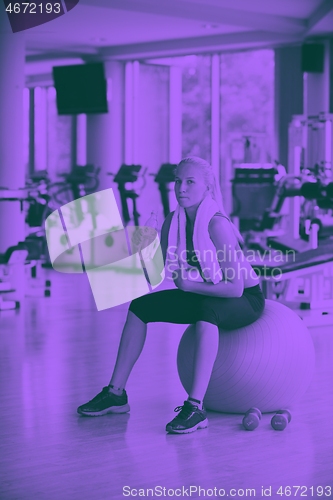 Image of woman in fitness gym drink water