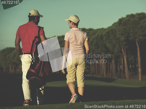 Image of couple walking on golf course