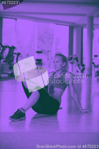 Image of woman stretching and warming up for her training at a gym