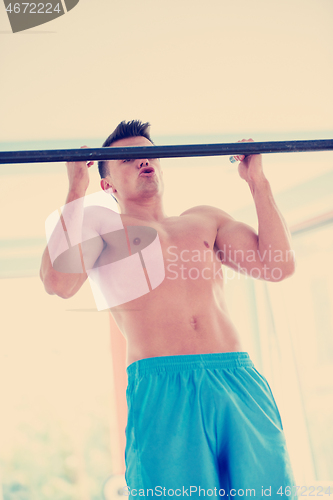 Image of handsome young mand working out in gym