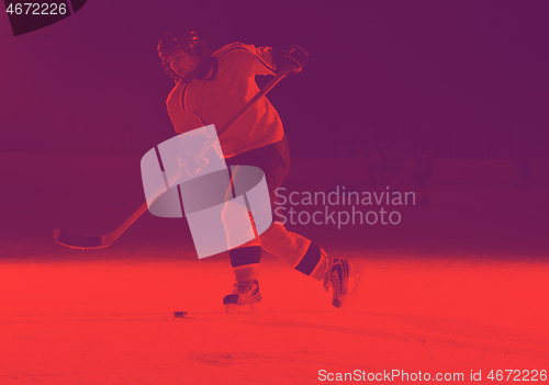 Image of teen ice hockey player in action