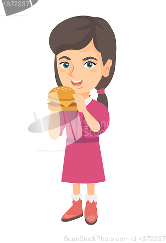 Image of Little caucasian girl eating a hamburger.