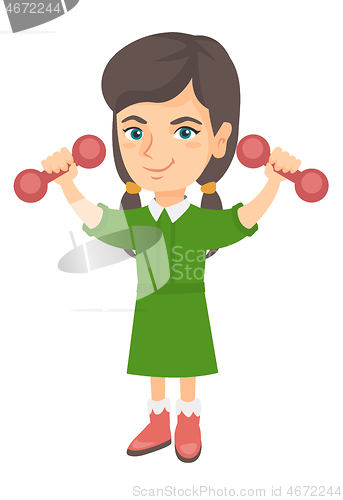 Image of Little smiling caucasian girl holding dumbbells.
