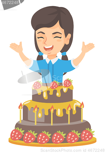 Image of Little caucasian girl jumping out of a large cake.