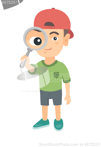 Image of Caucasian boy looking through a magnifying glass.