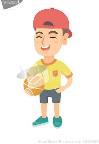 Image of Laughing schoolboy holding a basketball ball.