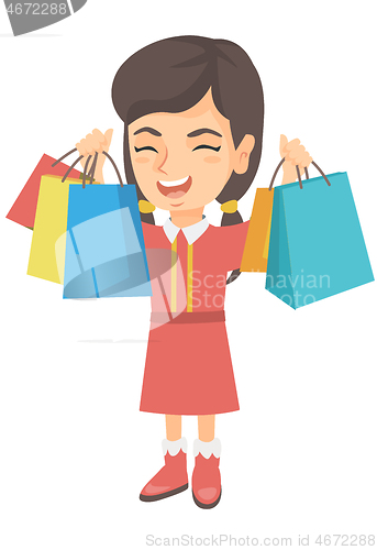 Image of Happy caucasian girl holding shopping bags.