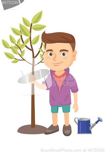 Image of Caucasian smiling boy planting a tree.