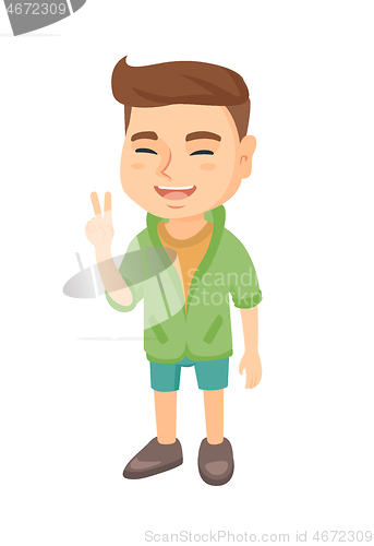 Image of Caucasian little boy showing victory gesture.