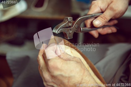 Image of Enjoying process of creation custom made shoes. Workplace of shoe designer