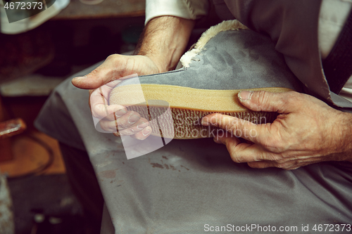 Image of Enjoying process of creation custom made shoes. Workplace of shoe designer