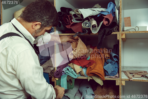 Image of Tailor man working in his tailor shop, Tailoring, close up