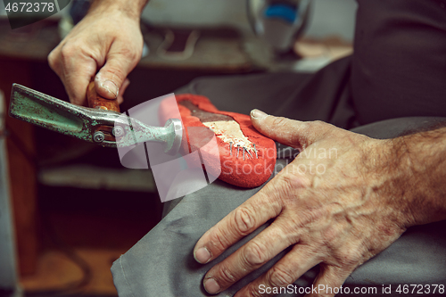 Image of Enjoying process of creation custom made shoes. Workplace of shoe designer