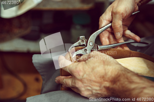 Image of Enjoying process of creation custom made shoes. Workplace of shoe designer