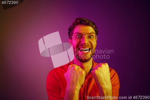 Image of Winning success man happy ecstatic celebrating being a winner. Dynamic energetic image of male model