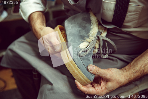 Image of Enjoying process of creation custom made shoes. Workplace of shoe designer