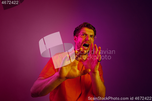 Image of Portrait of the scared man on pink