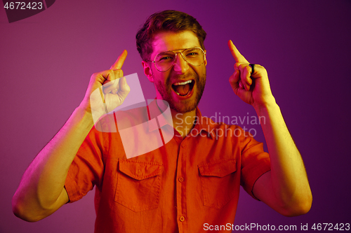 Image of The happy business man standing and smiling against pink background.