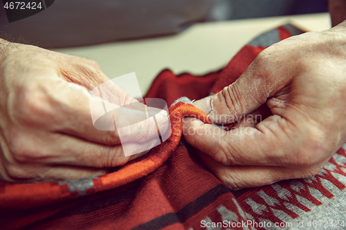 Image of Tailor man working in his tailor shop, Tailoring, close up