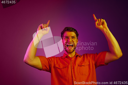 Image of Winning success man happy ecstatic celebrating being a winner. Dynamic energetic image of male model