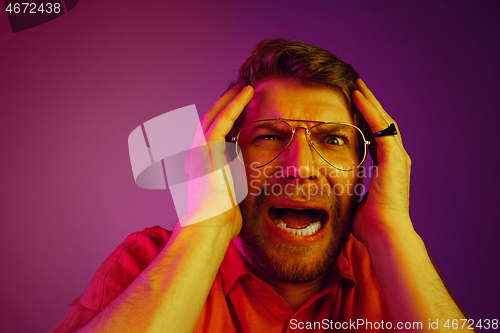 Image of Portrait of the scared man on pink