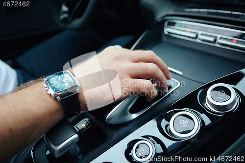 Image of hand on automatic gear shift, Man hand shifting an automatic car