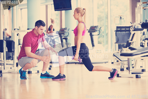 Image of young sporty woman with trainer exercise weights lifting