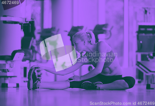 Image of woman stretching and warming up for her training at a gym