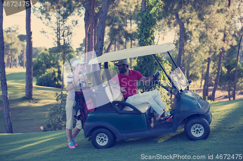 Image of couple in buggy on golf course