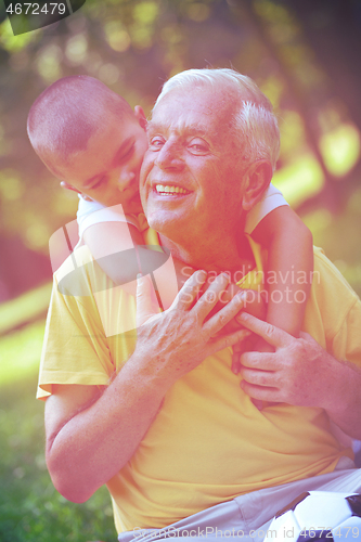 Image of happy grandfather and child in park